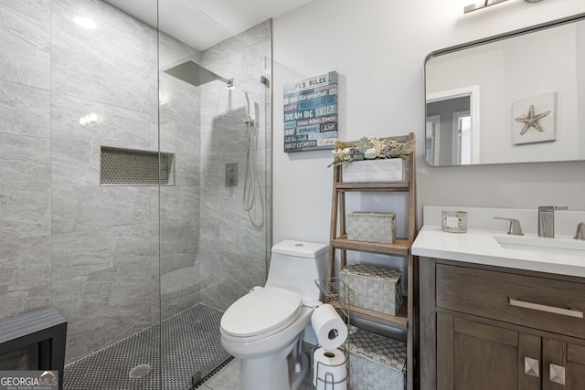 full bathroom featuring toilet, walk in shower, and vanity