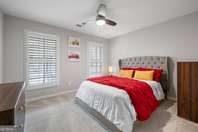 bedroom with multiple windows, carpet flooring, baseboards, and visible vents