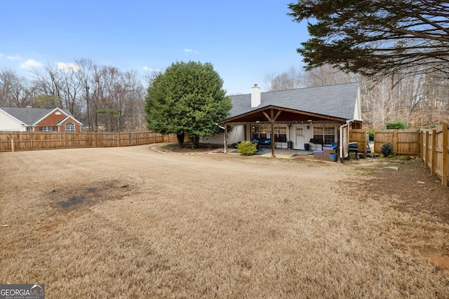 view of yard with a fenced backyard and a patio