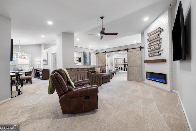 living room with baseboards, recessed lighting, light carpet, a barn door, and ceiling fan with notable chandelier