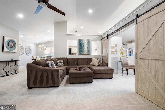 living room with light carpet, recessed lighting, ceiling fan with notable chandelier, and a barn door