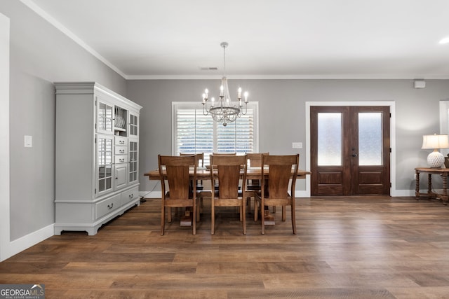 dining space with visible vents, plenty of natural light, french doors, and wood finished floors