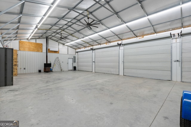 garage with electric panel and metal wall