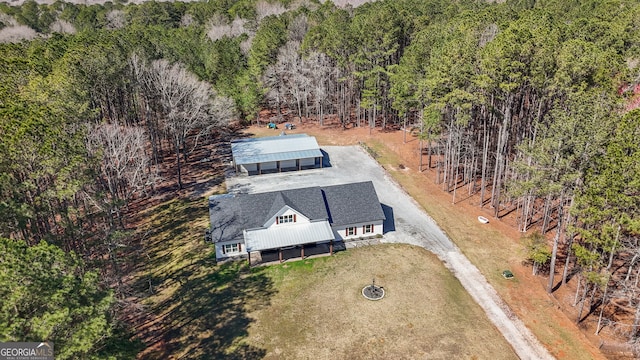 drone / aerial view with a wooded view