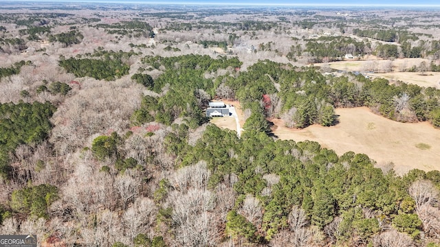 drone / aerial view featuring a forest view