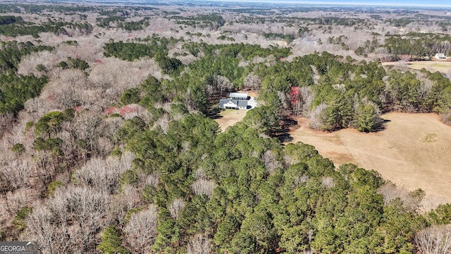 drone / aerial view featuring a wooded view