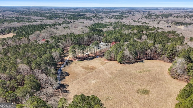 drone / aerial view featuring a view of trees