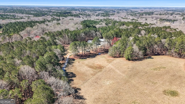 drone / aerial view featuring a view of trees