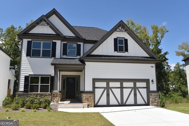480 Brown Dove Ln, Grayson, GA 30017 - view of front facade with stone siding, board and batten siding, driveway, and a front lawn