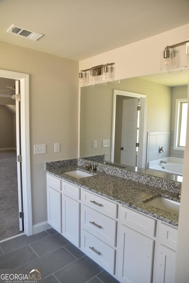 480 Brown Dove Ln, Grayson, GA 30017 - full bathroom featuring tile patterned floors, double vanity, visible vents, and a sink