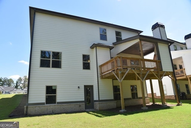 480 Brown Dove Ln, Grayson, GA 30017 - back of property featuring brick siding, a chimney, a wooden deck, and a yard