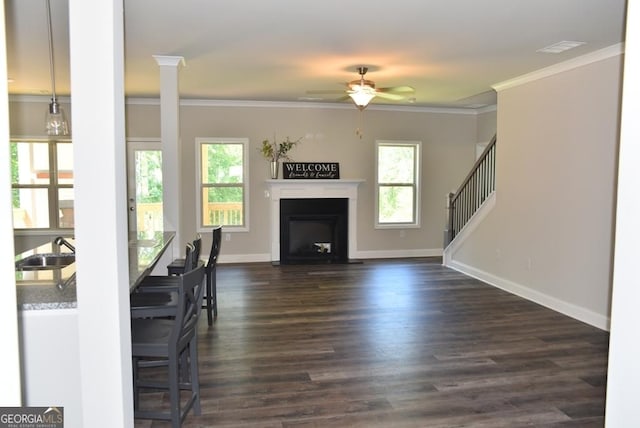 480 Brown Dove Ln, Grayson, GA 30017 - unfurnished living room featuring dark wood-style flooring, ornamental molding, baseboards, and a sink
