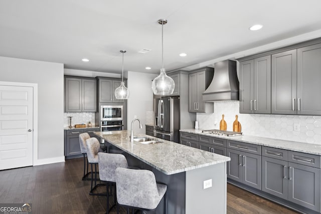 3119 Stonegate Dr SW, Atlanta, GA 30331 - kitchen with dark wood-type flooring, premium range hood, light stone counters, appliances with stainless steel finishes, and a sink