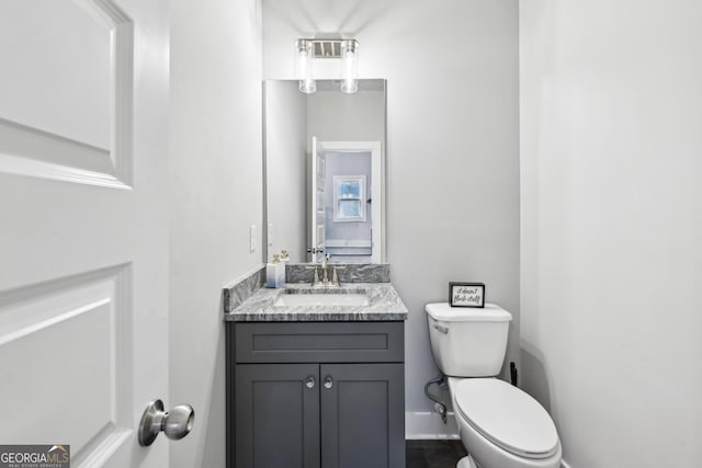 3119 Stonegate Dr SW, Atlanta, GA 30331 - bathroom with baseboards, toilet, and vanity