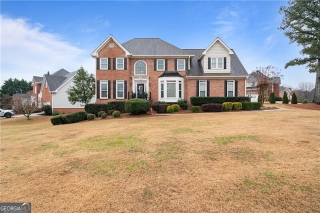 view of front of house with a front lawn and brick siding