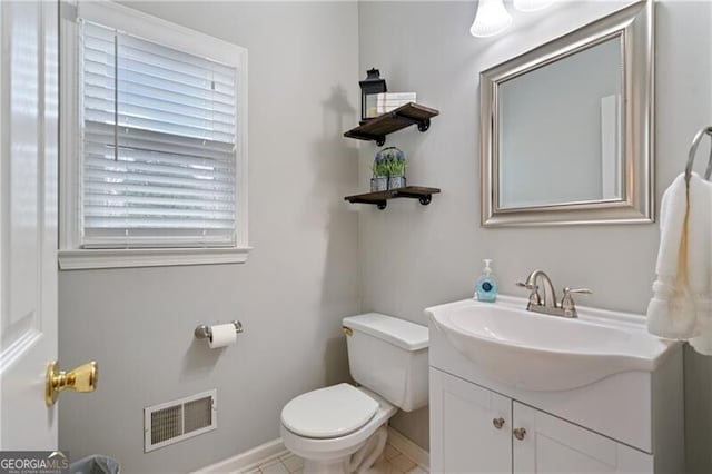 half bath featuring visible vents, baseboards, toilet, and vanity