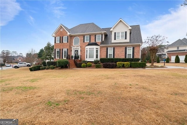 view of front of property featuring brick siding and a front lawn