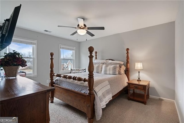 bedroom with multiple windows, baseboards, visible vents, and ceiling fan