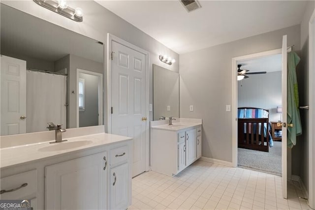 ensuite bathroom with visible vents, two vanities, ensuite bathroom, a ceiling fan, and a sink