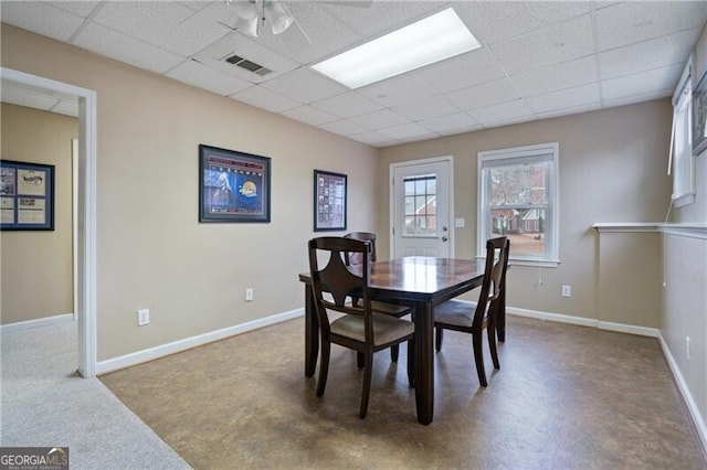 dining area with a ceiling fan, a paneled ceiling, visible vents, and baseboards