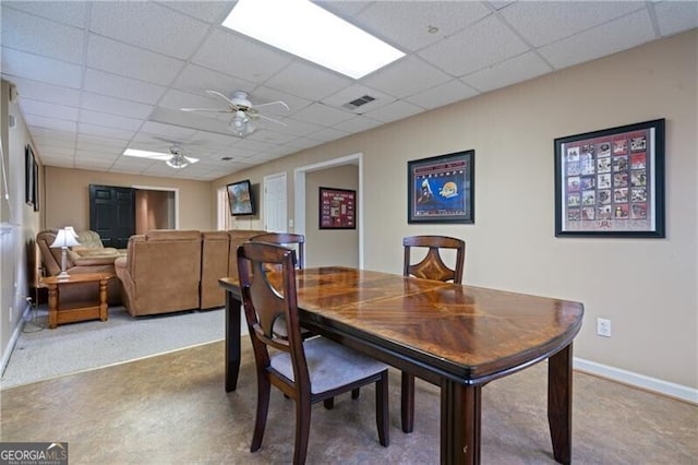 dining area with visible vents, a ceiling fan, baseboards, and a drop ceiling