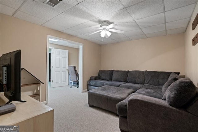 living room with a ceiling fan, visible vents, baseboards, a drop ceiling, and carpet flooring