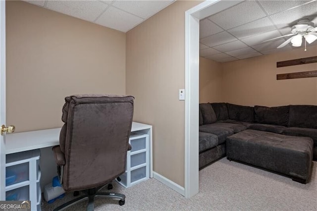 home office with a drop ceiling, carpet flooring, and baseboards