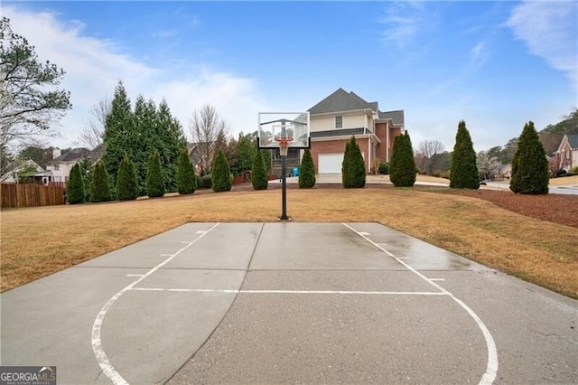 view of sport court featuring a yard, community basketball court, and fence