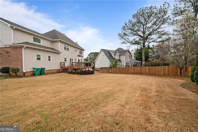 view of yard featuring a deck and fence