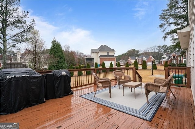 wooden terrace featuring a grill and outdoor lounge area