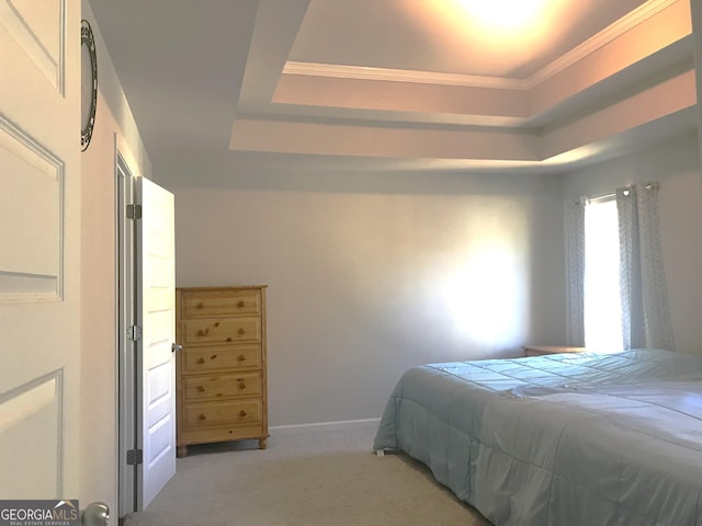 bedroom featuring baseboards, a raised ceiling, and light carpet