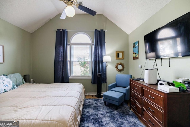 bedroom featuring ceiling fan, lofted ceiling, and a textured ceiling