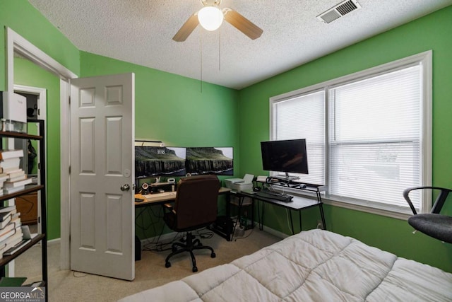 bedroom with visible vents, a textured ceiling, and carpet flooring