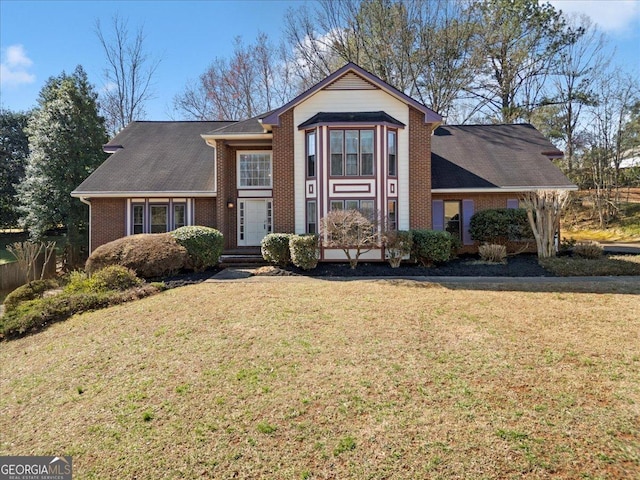 traditional home with brick siding and a front yard