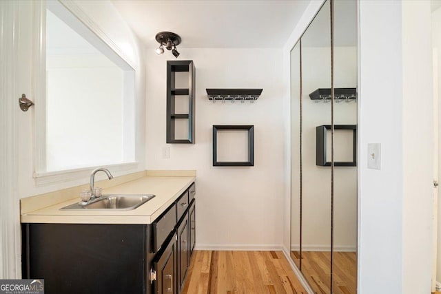 interior space with baseboards, wood finished floors, and vanity