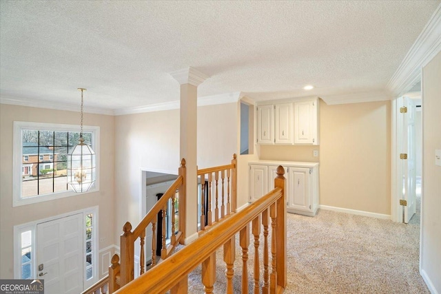 hallway with baseboards, light carpet, an upstairs landing, and crown molding