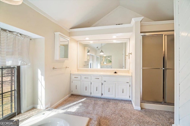 bathroom with vanity, vaulted ceiling, baseboards, and a stall shower