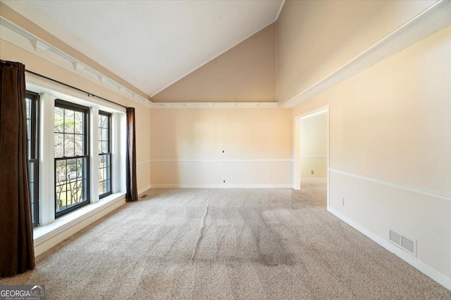 unfurnished room with visible vents, carpet floors, high vaulted ceiling, and baseboards