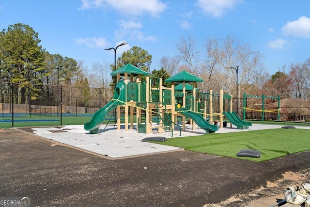 community jungle gym featuring fence