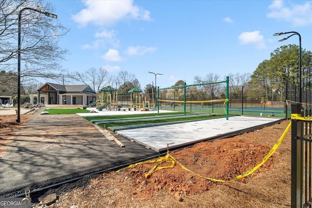 view of community featuring playground community and fence