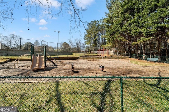 communal playground featuring fence