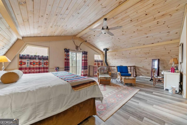 bedroom featuring wood finished floors, lofted ceiling, wooden ceiling, and a wood stove