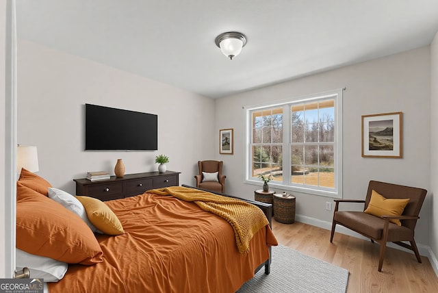 bedroom featuring light wood-type flooring and baseboards
