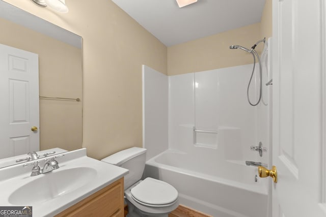 bathroom featuring toilet,  shower combination, and vanity