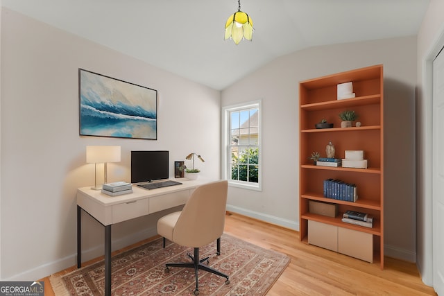 office area with wood finished floors, baseboards, and vaulted ceiling