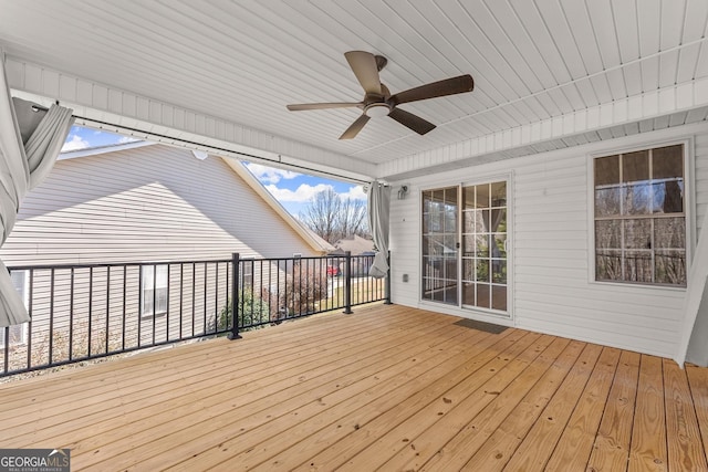 wooden deck featuring a ceiling fan
