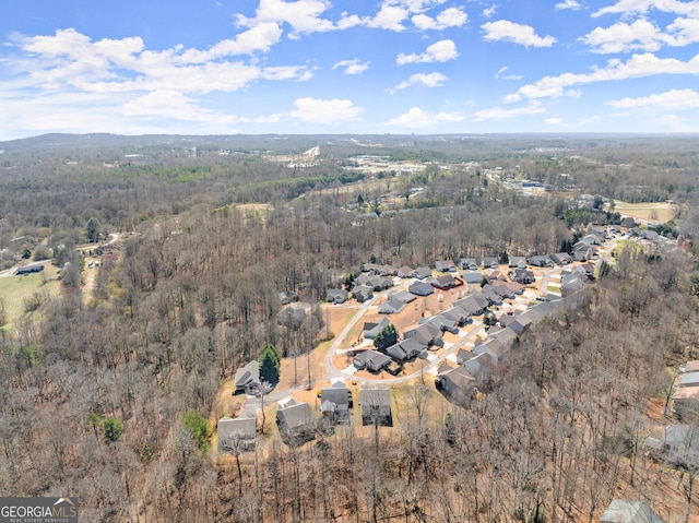 birds eye view of property with a forest view