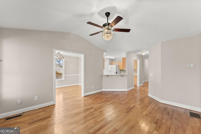unfurnished living room featuring visible vents, light wood-type flooring, ceiling fan, and vaulted ceiling