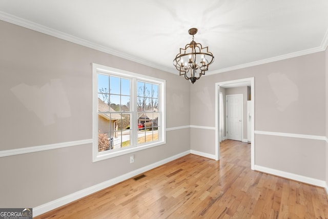 unfurnished dining area featuring visible vents, baseboards, light wood-style flooring, and crown molding