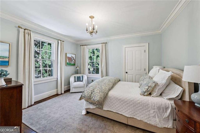 bedroom featuring wood finished floors, baseboards, an inviting chandelier, and ornamental molding